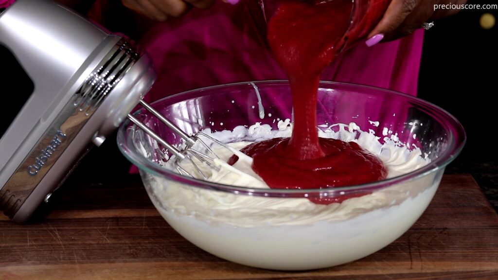 Adding strawberry puree to whipped cream