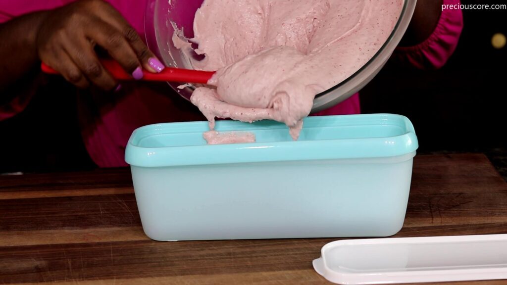 Pouring strawberry ice cream mixture into ice cream bowl