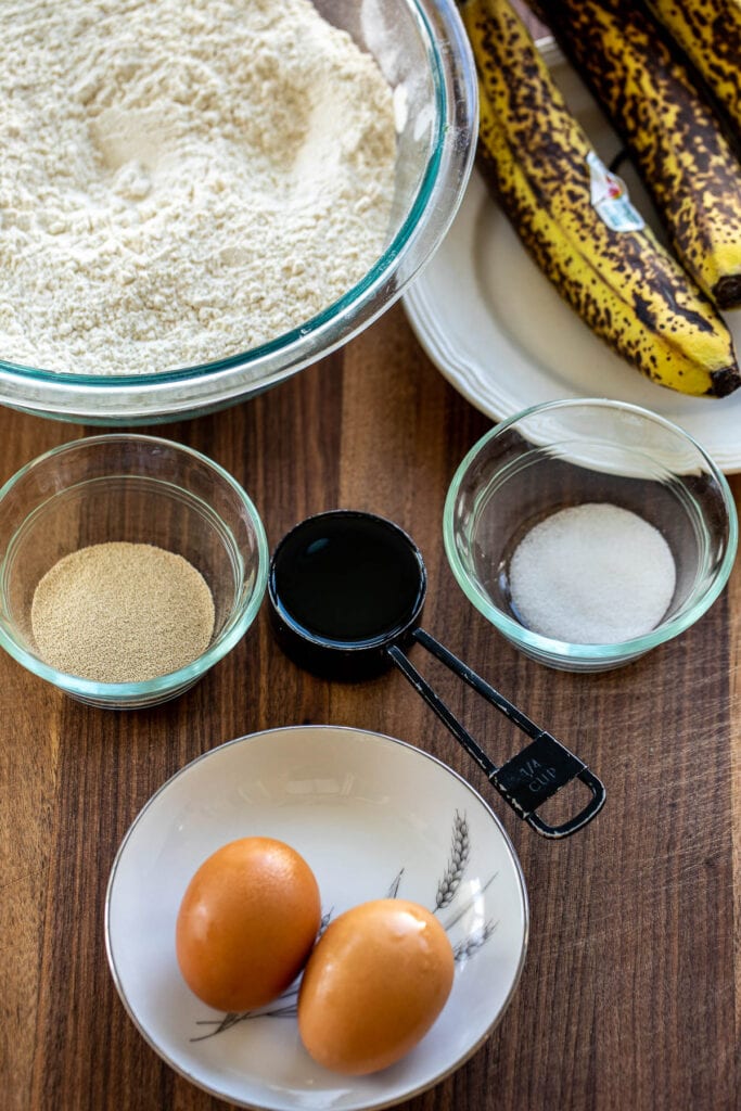 Ingredients for bread rolls made with banana on a chopping board