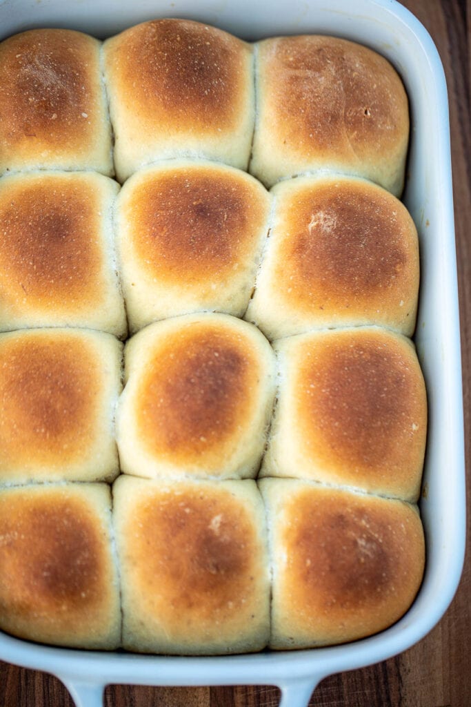 Fully baked bread rolls in pan
