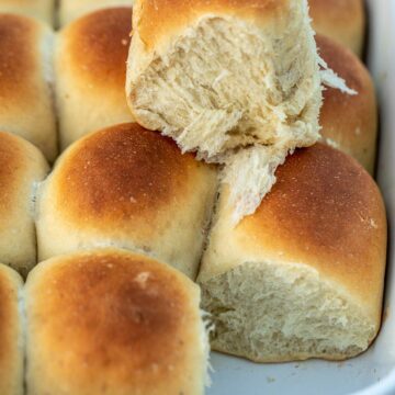 Rolls in a pan with one roll on top to show fluffiness