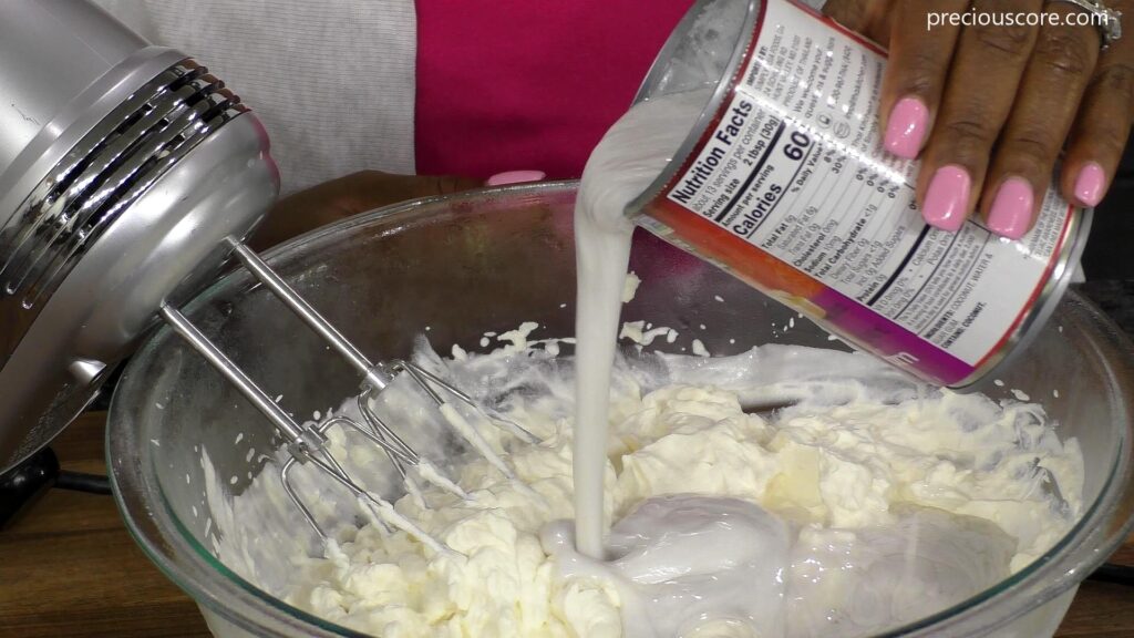 oconut cream pouring from can into bowl.