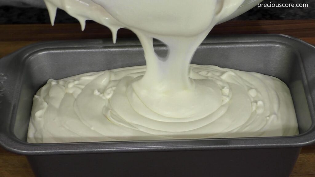 Coconut Ice Cream Mixture pouring into a loaf pan