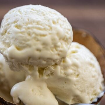 Scoops of ice cream in a bowl made from a coconut shell