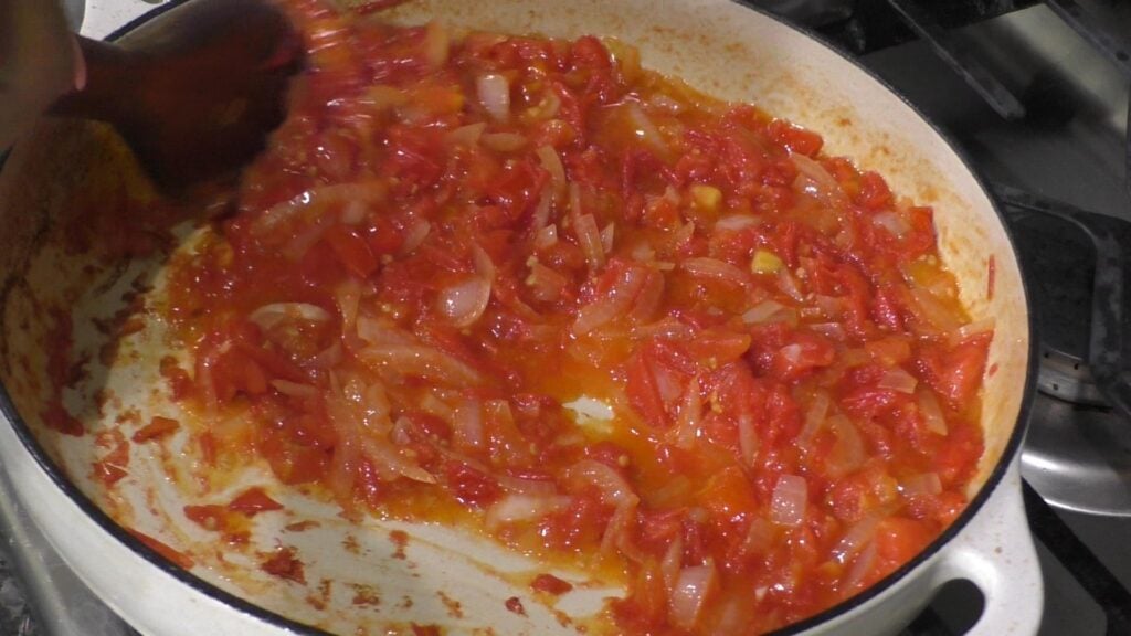 Tomatoes and onions cooking in pot