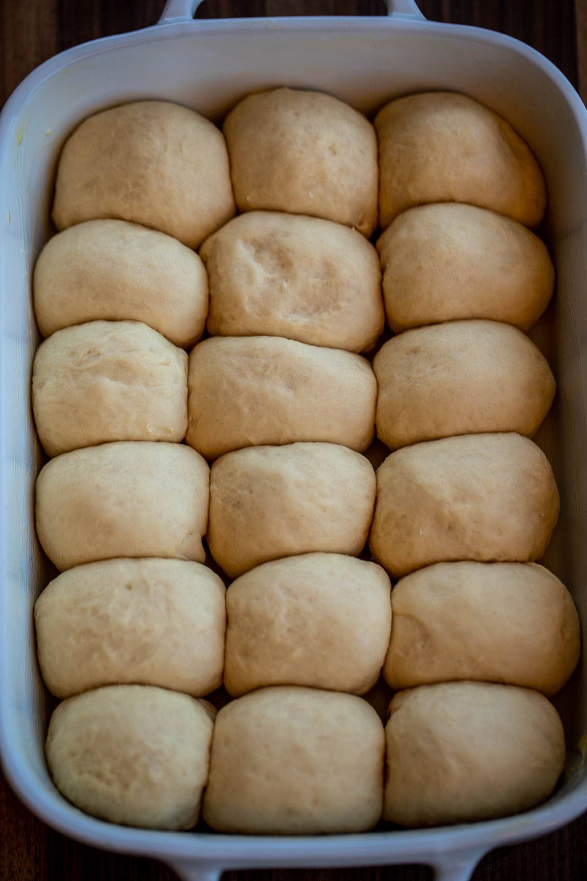 Risen rolls in baking dish