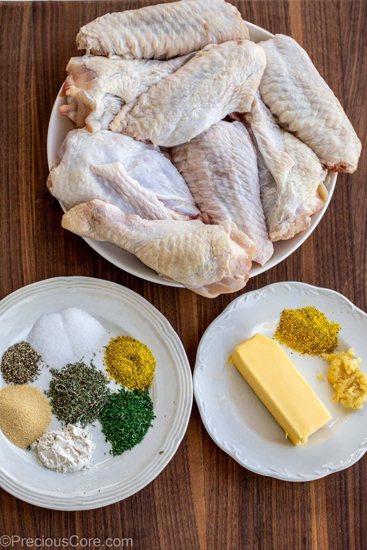 Turkey Wings, seasoning and butter on a chopping board.