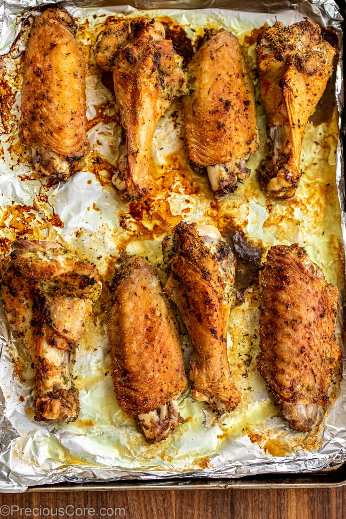 Roasted turkey wings on a baking sheet.