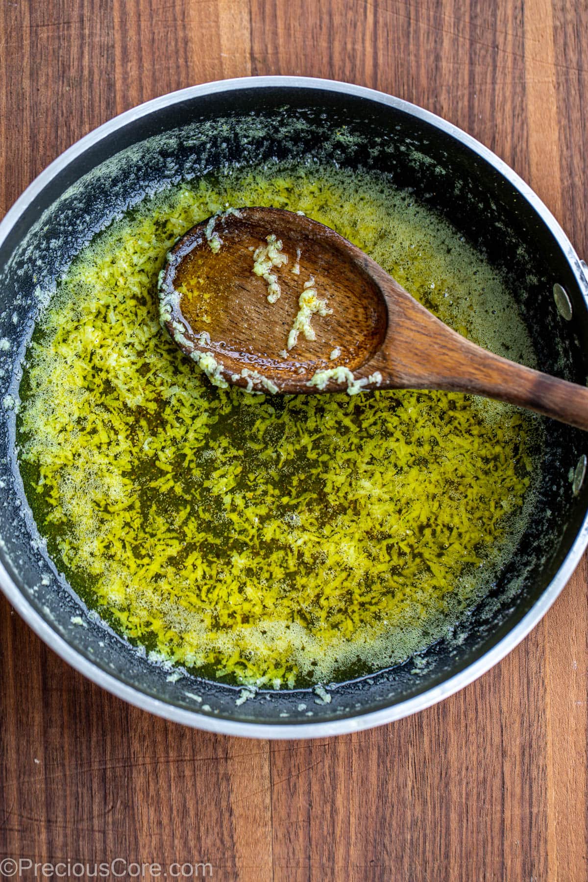 Butter sauce with lemon pepper seasoning in a skillet.