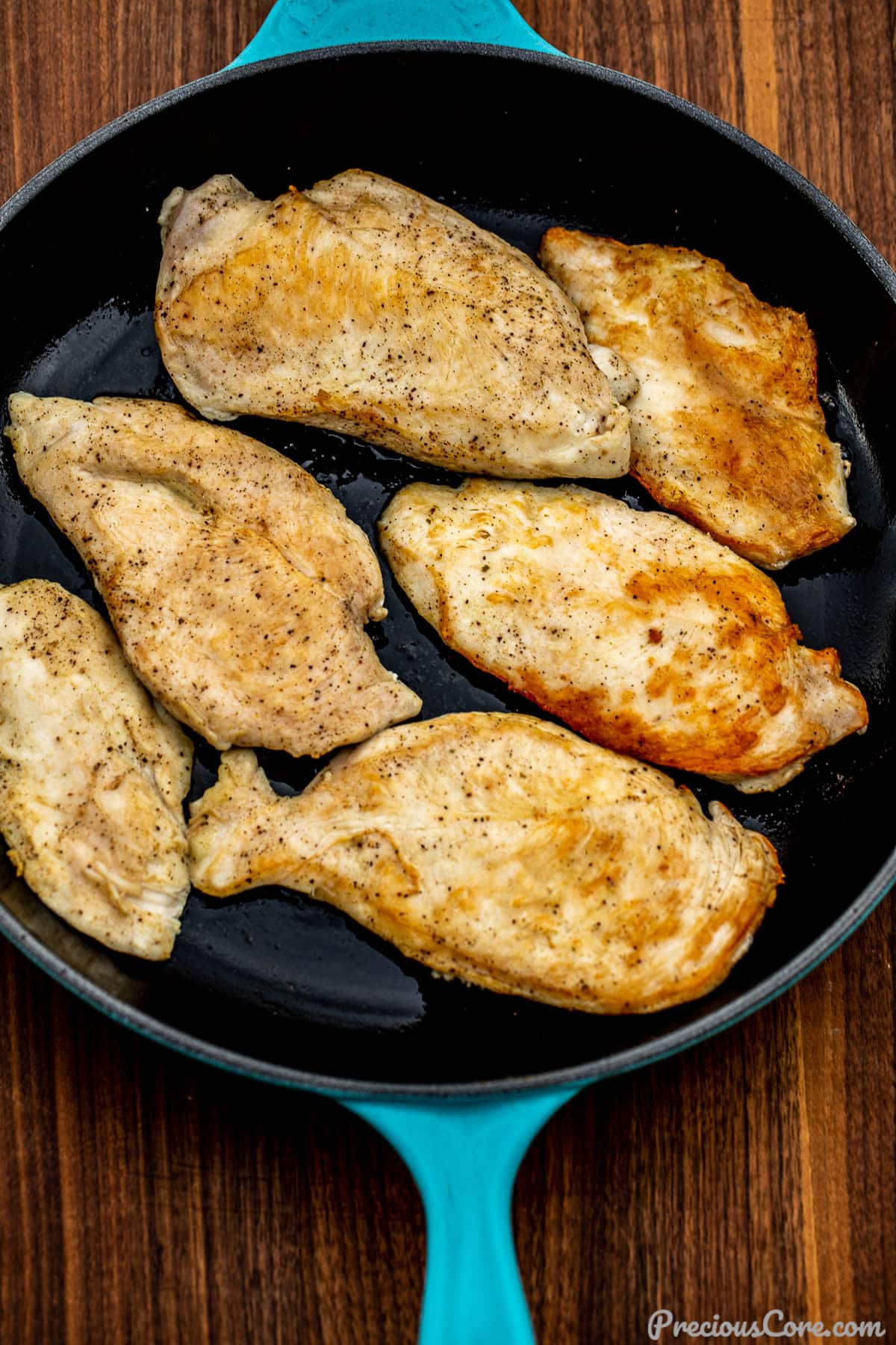 Pan seared chicken breasts in a large skillet.