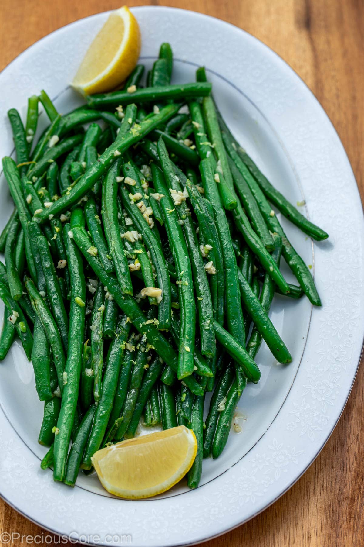 Garlic butter green beans on tray with lemon juice.