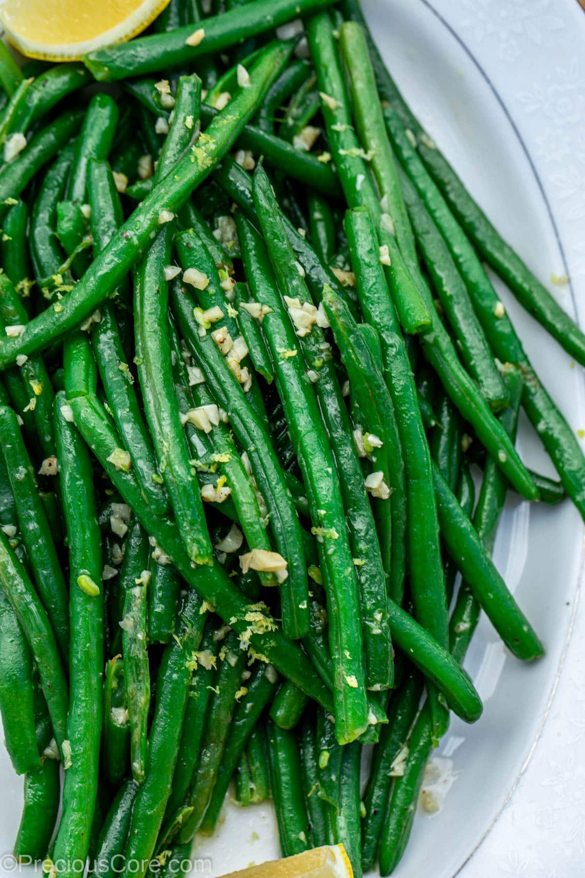 Cooked green beans on a serving tray.