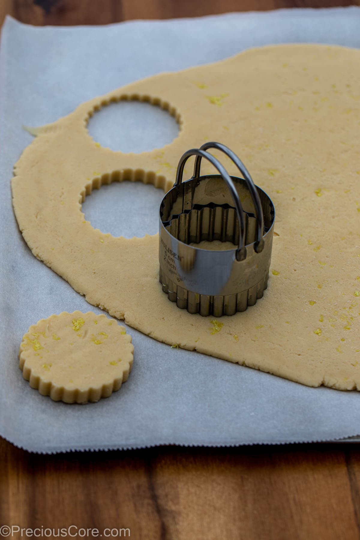2 inch cookie cutter on dough for cutting out 2-inch circle cookies.