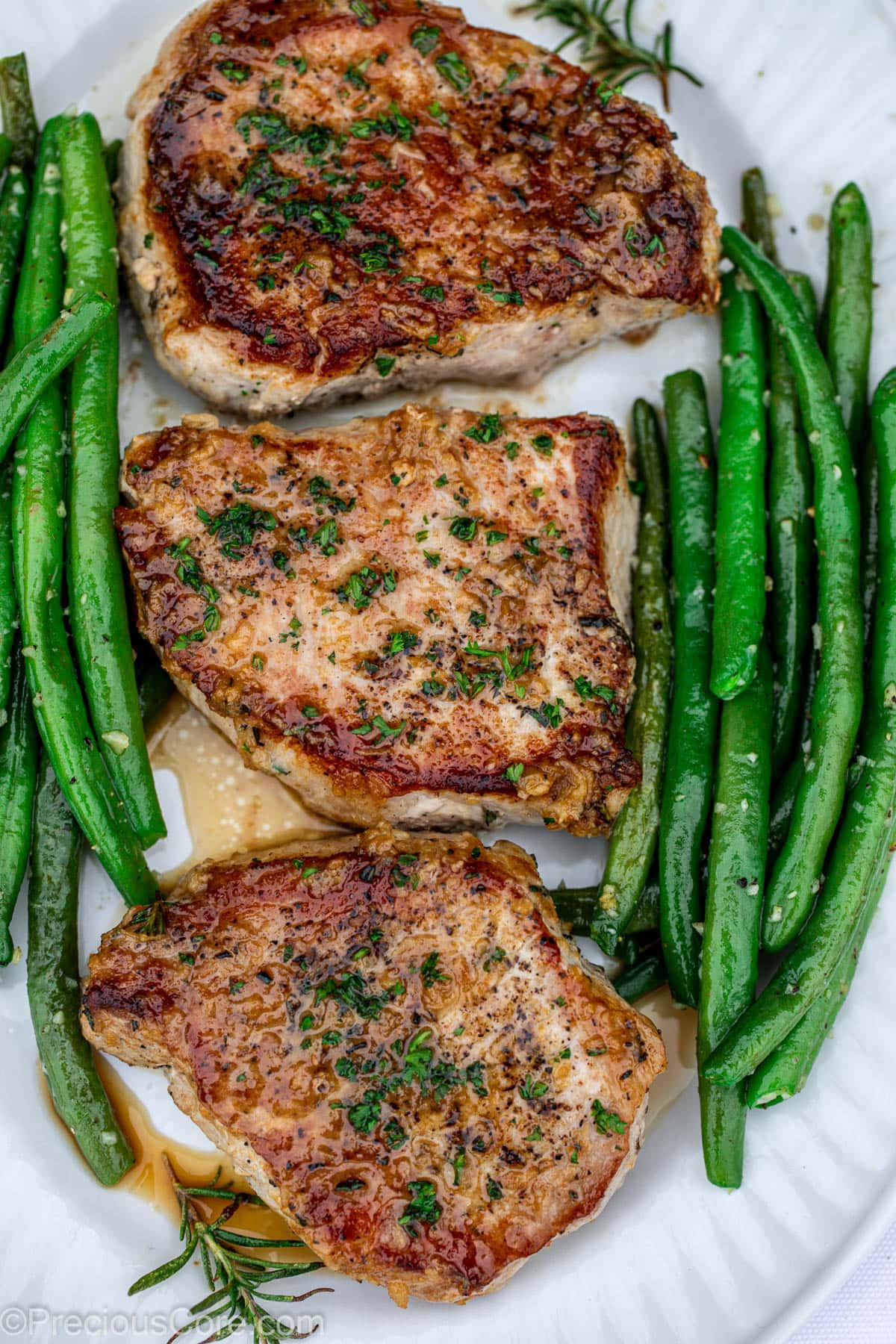 Pork Chops in a pan with green beans.