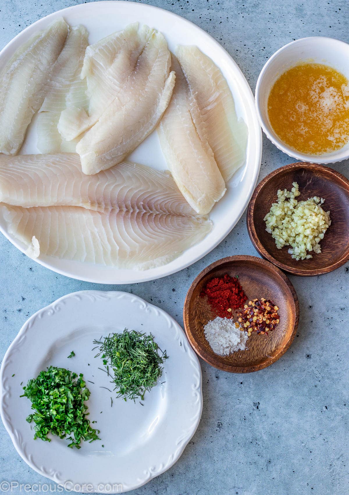 Ingredients for Garlic Butter Tilapia on a slab