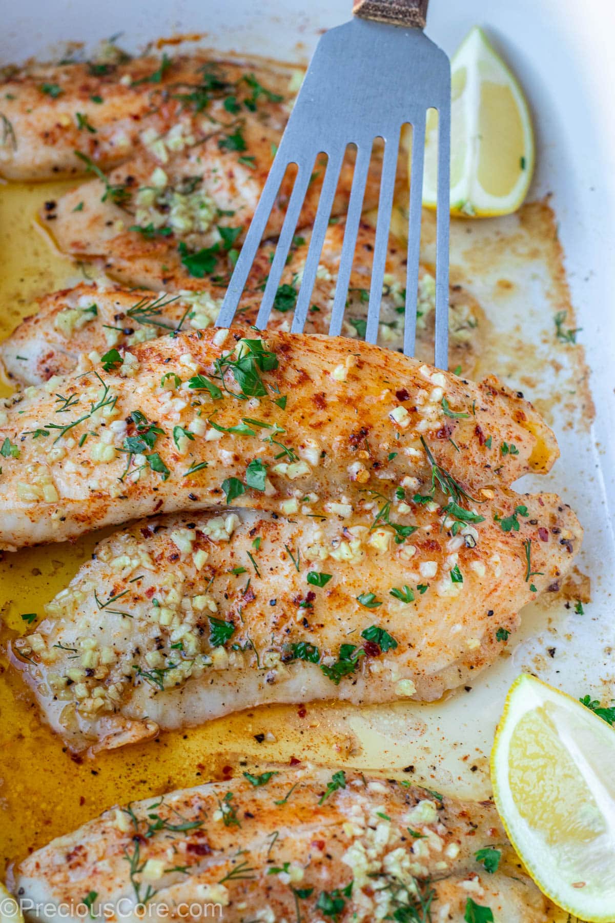 Tilapia fillet with garlic butter on top.