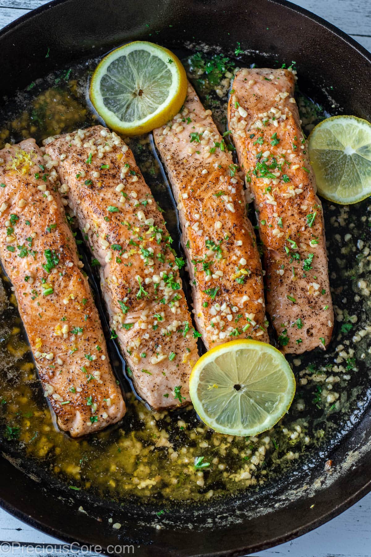 4 pieces of salmon in a cast iron skillet.