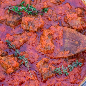 Big pot of red tomato beef stew.