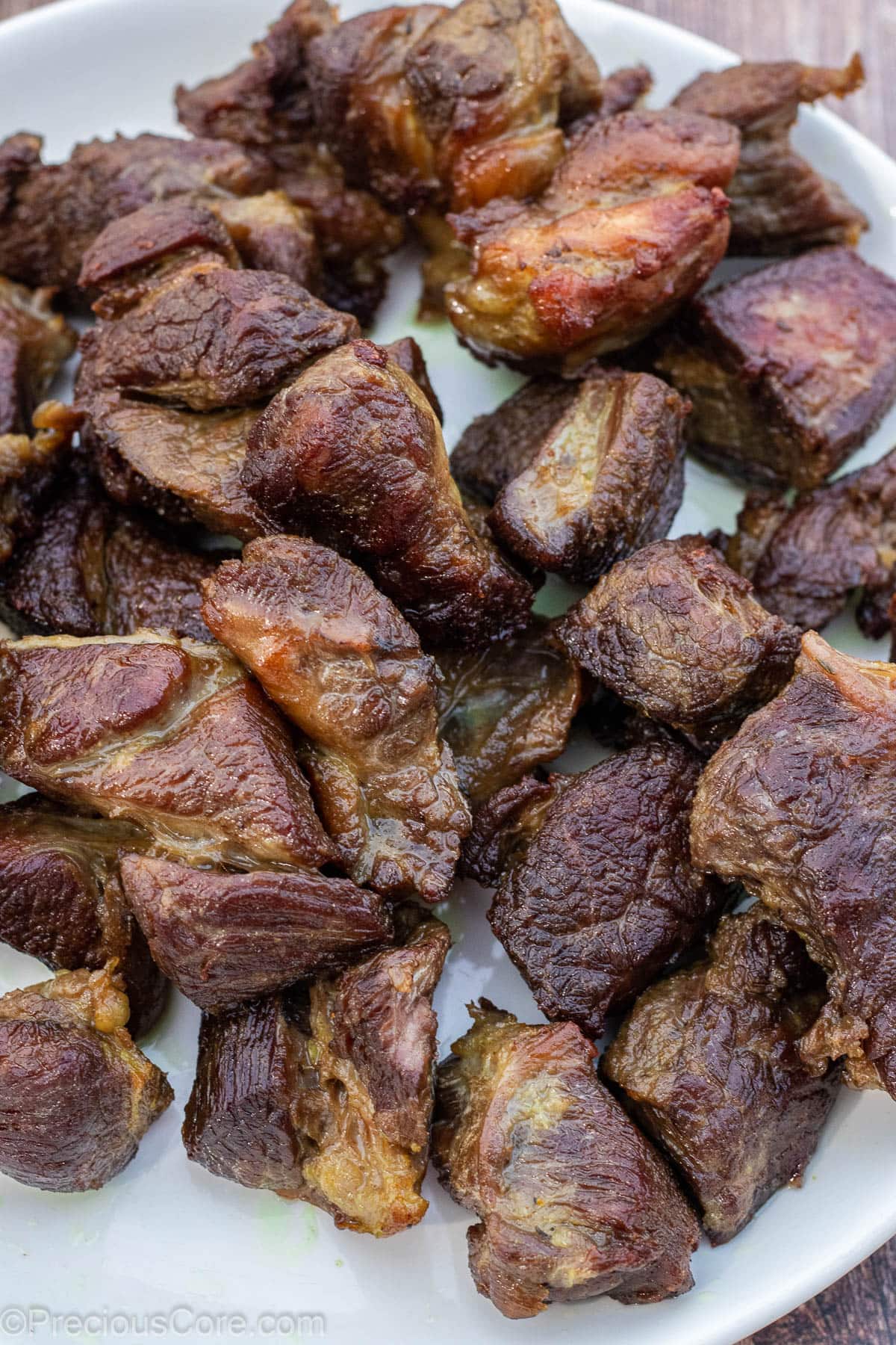 Fried beef on a white plate.