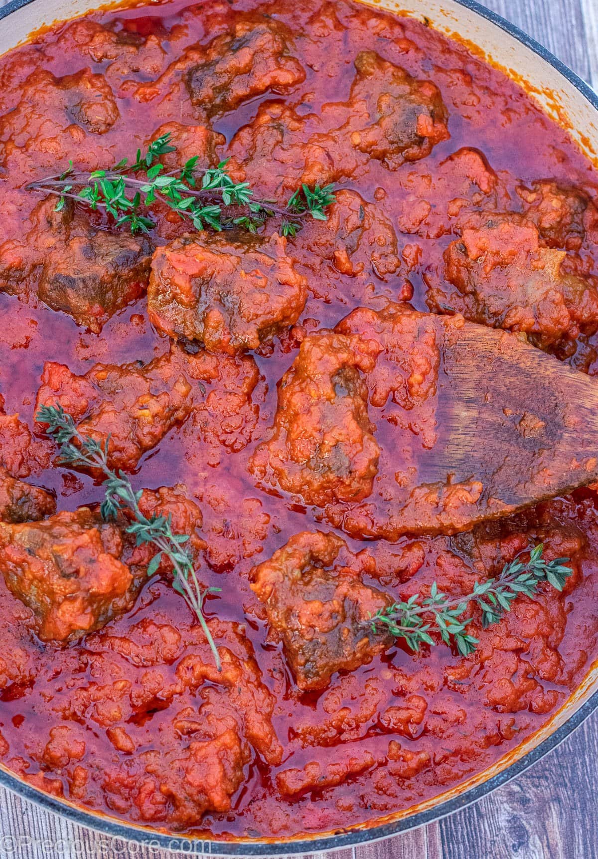 Big pot of red tomato beef stew.