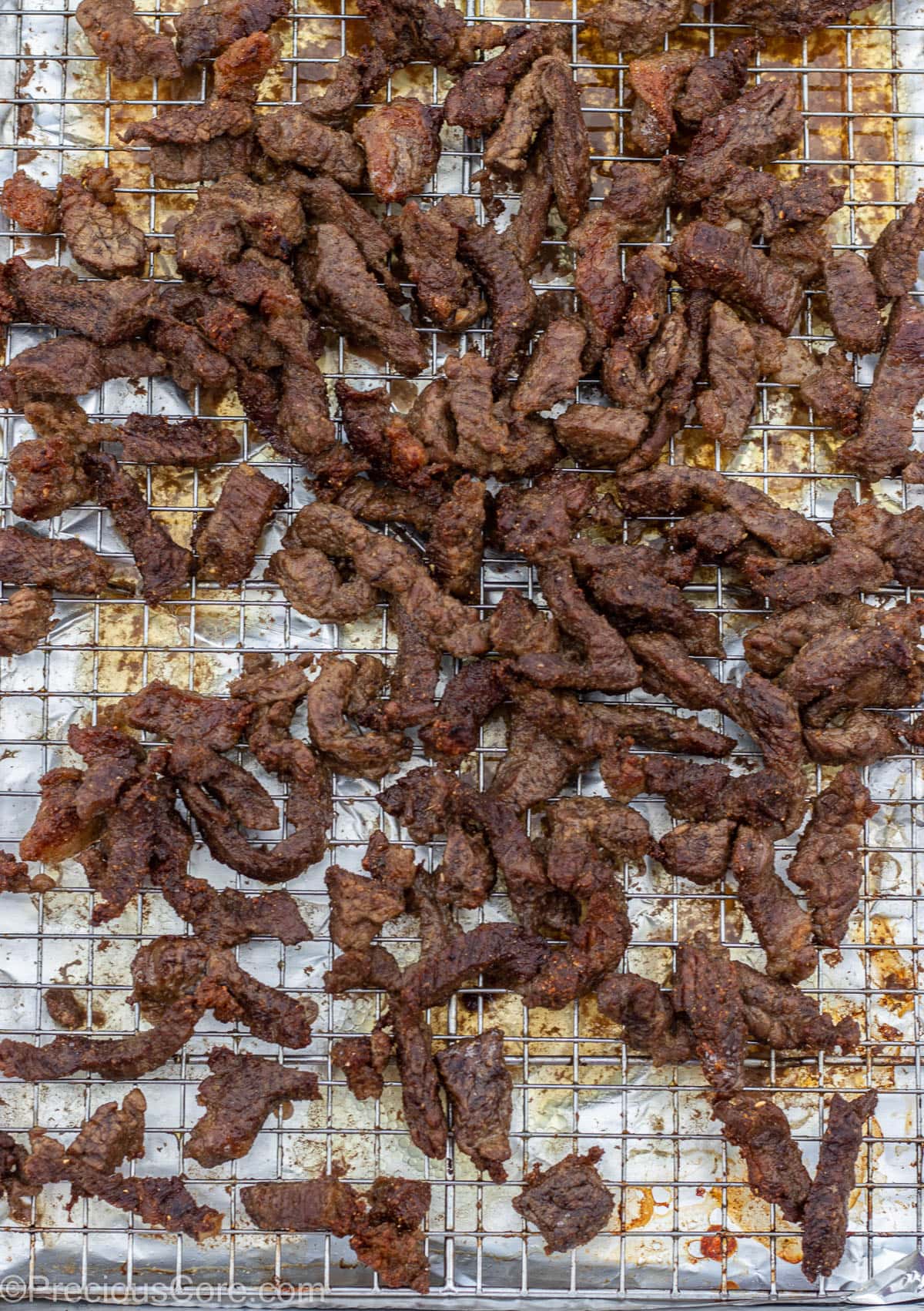 Grilled Cameroonian soya on a baking sheet rack.