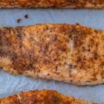 Baked Cajun salmon on parchment paper.