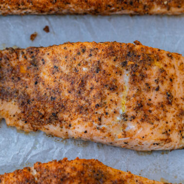 Square image of baked salmon.