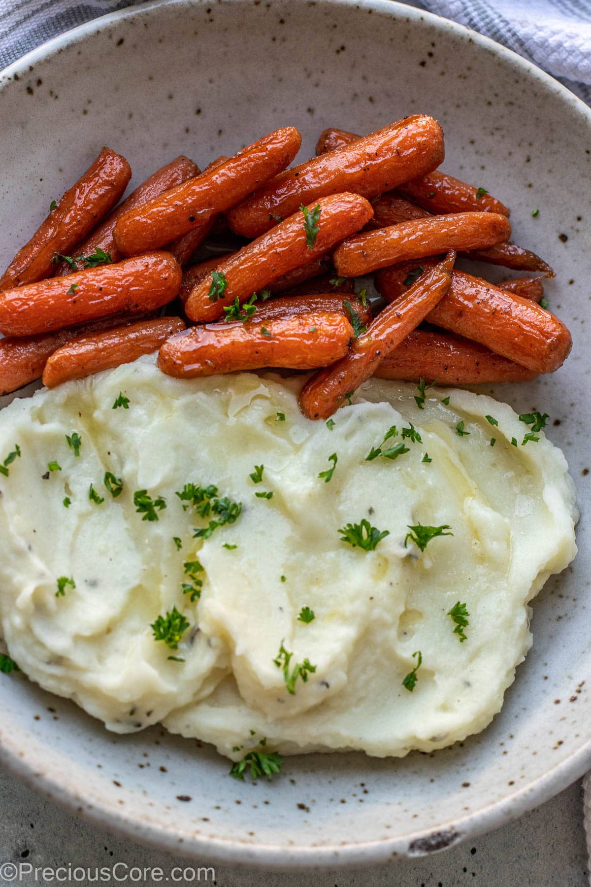 Mashed potatoes and carrots in a bowl.