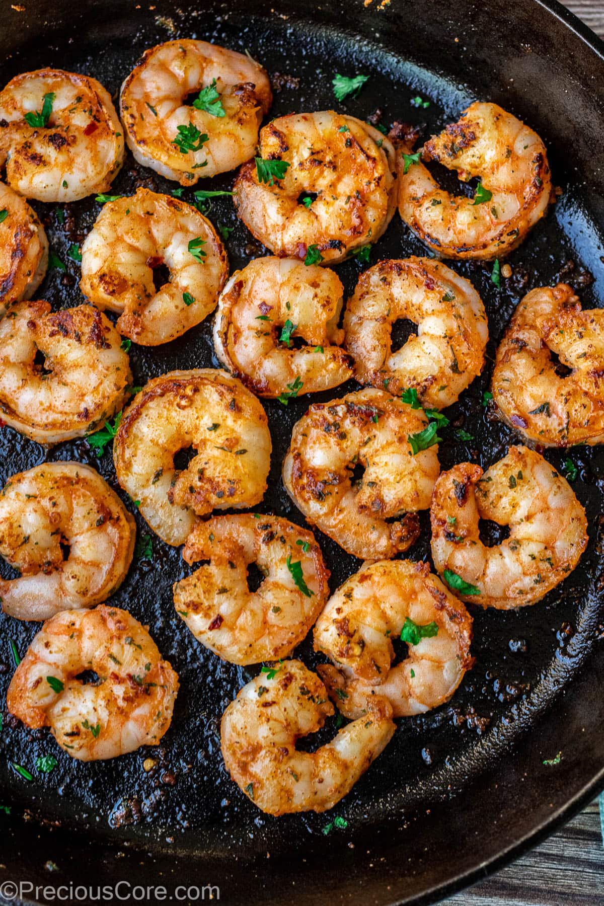 Pan seared shrimp in a skillet.