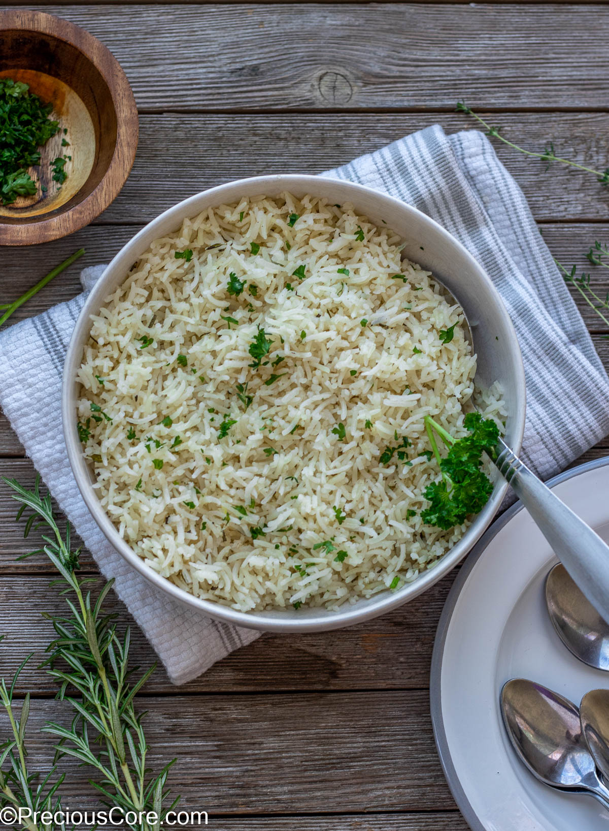 Bowl of seasoned rice with plates on one side.