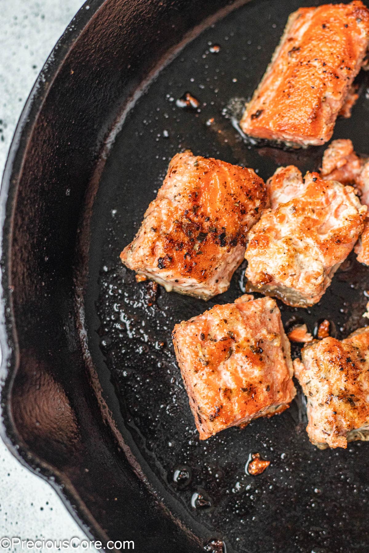 Salmon in a cast iron skillet.