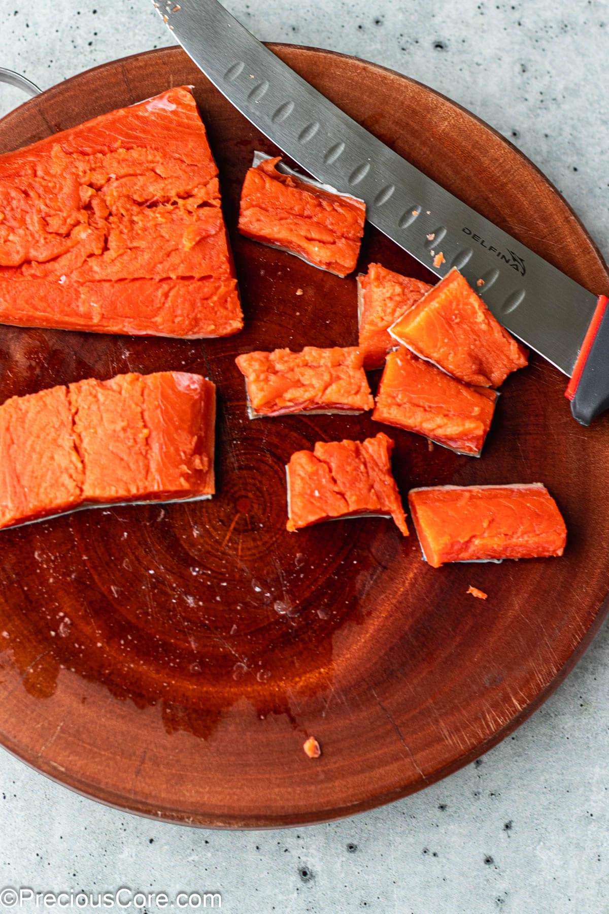 Cut salmon on a chopping board.