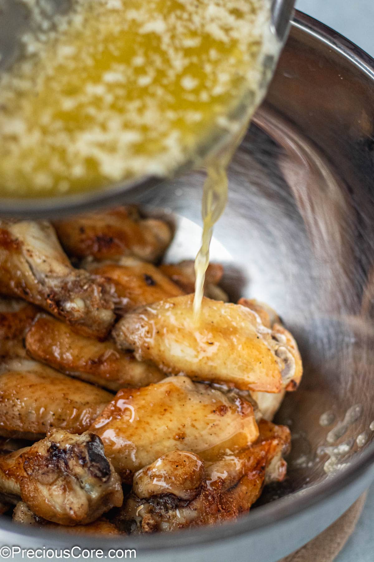 Garlic butter sauce pouring into chicken.