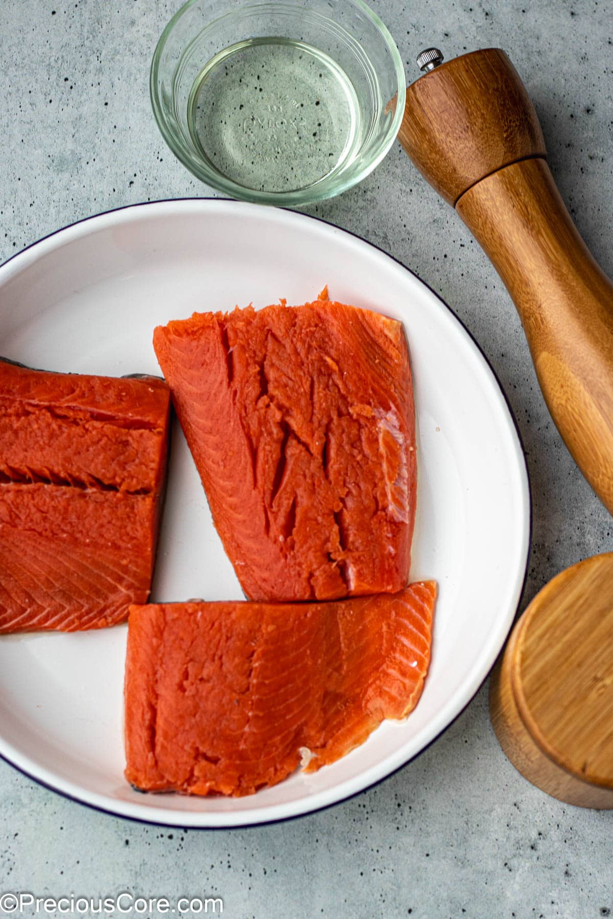 Fresh salmon, salt and pepper, and olive oil.