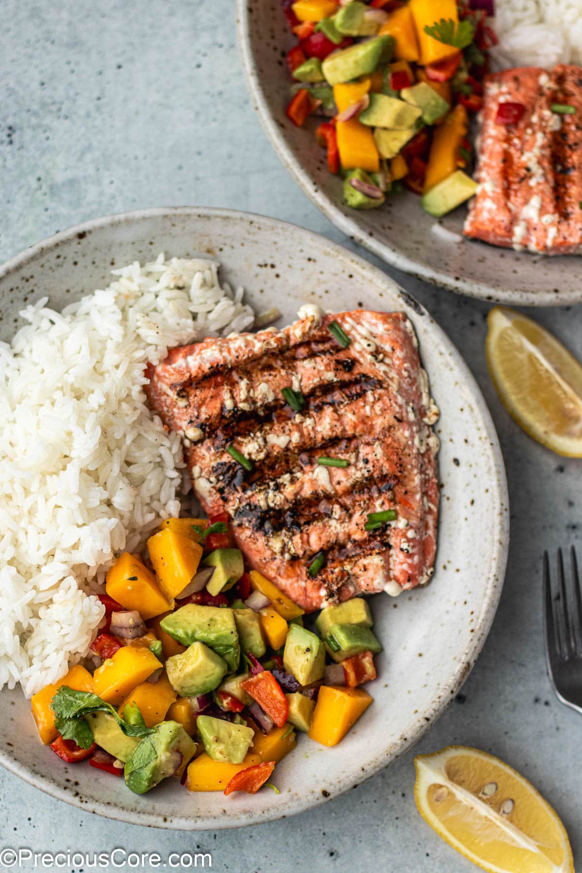 Grilled sockeye salmon in a bowl with rice and Mango Salsa.