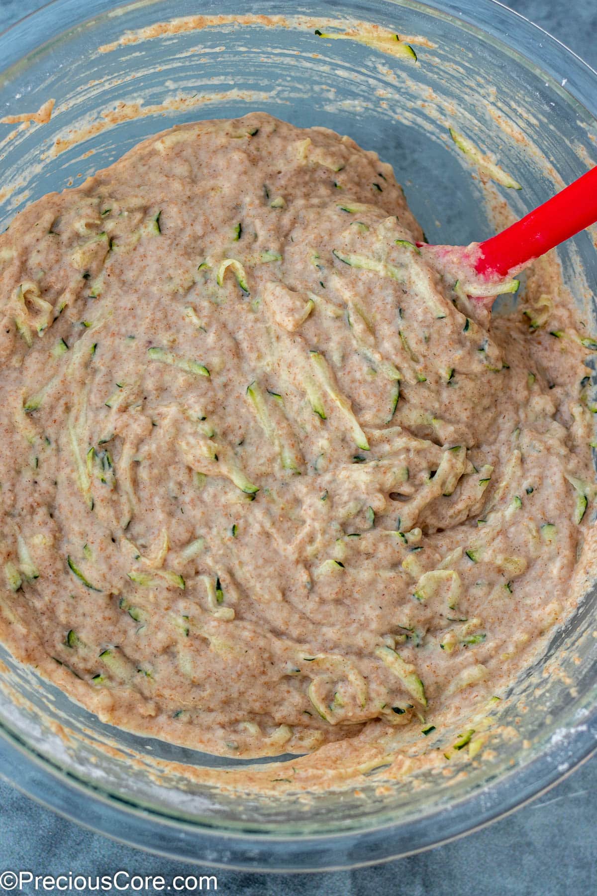 Complete batter for zucchini muffins with applesauce in a bowl.