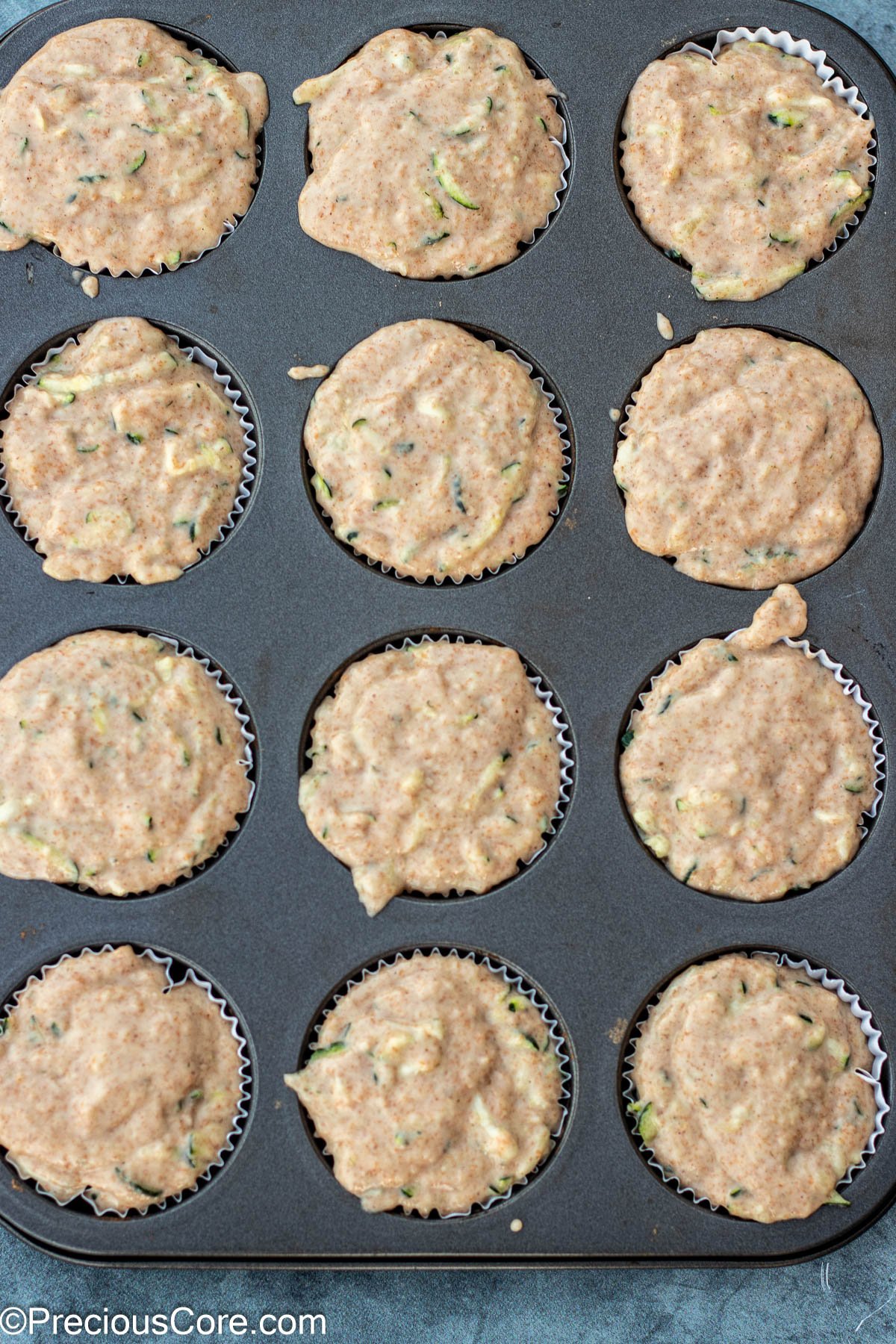 zucchini batter in muffin tin pan.