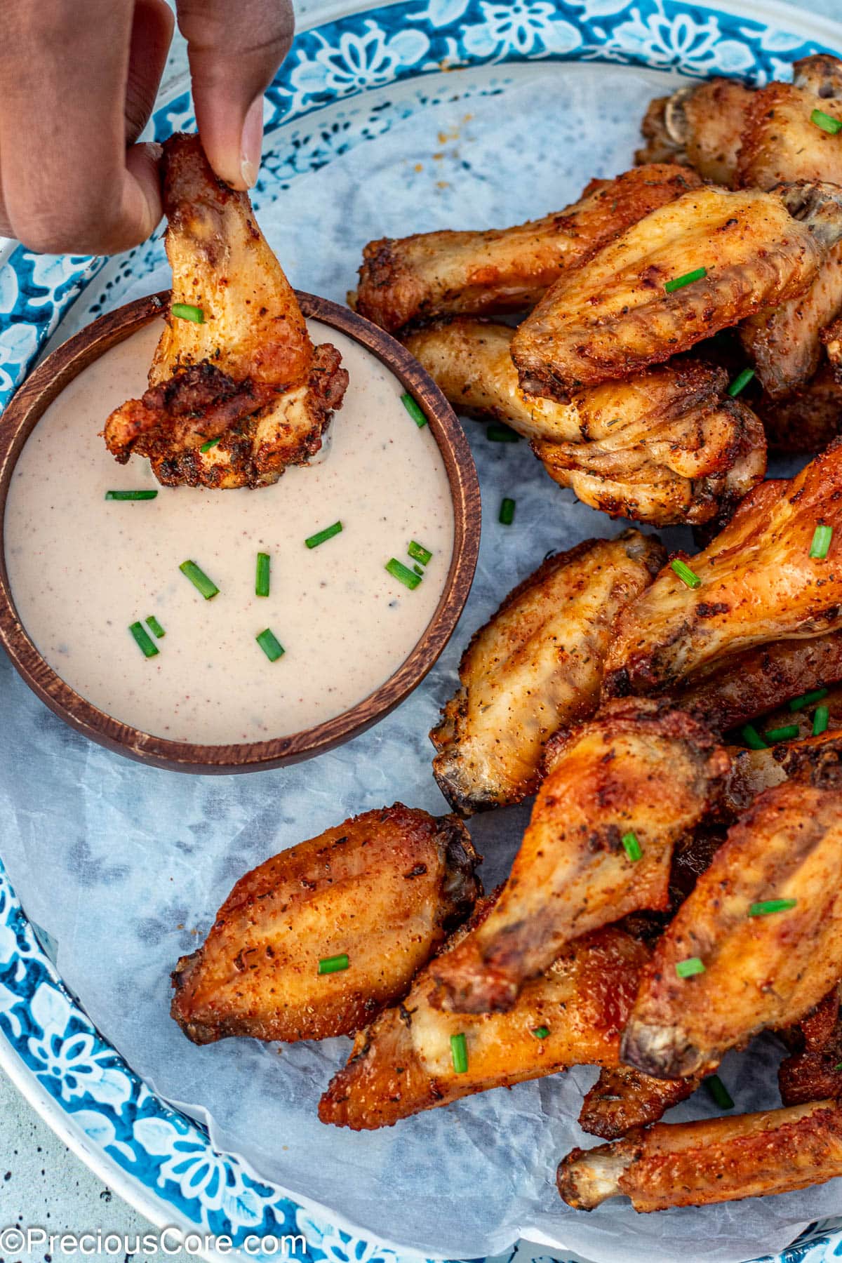 Dipping a wing into ranch.