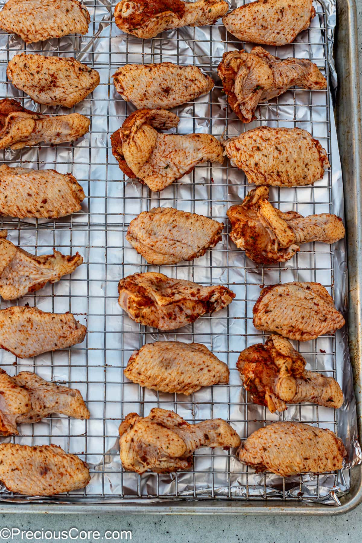 Wings placed on oven-safe baking rack.