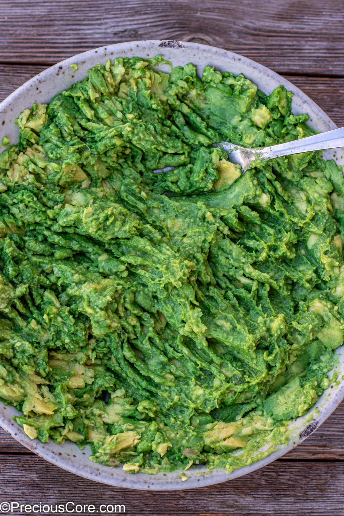 Mashed avocados in a bowl.