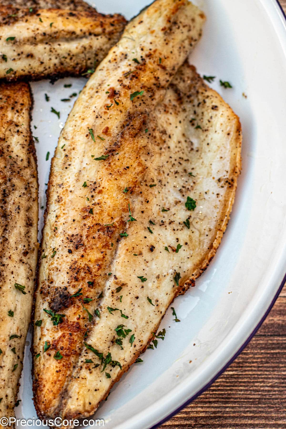 Pan Seared Sea Bass garnished with parsley.