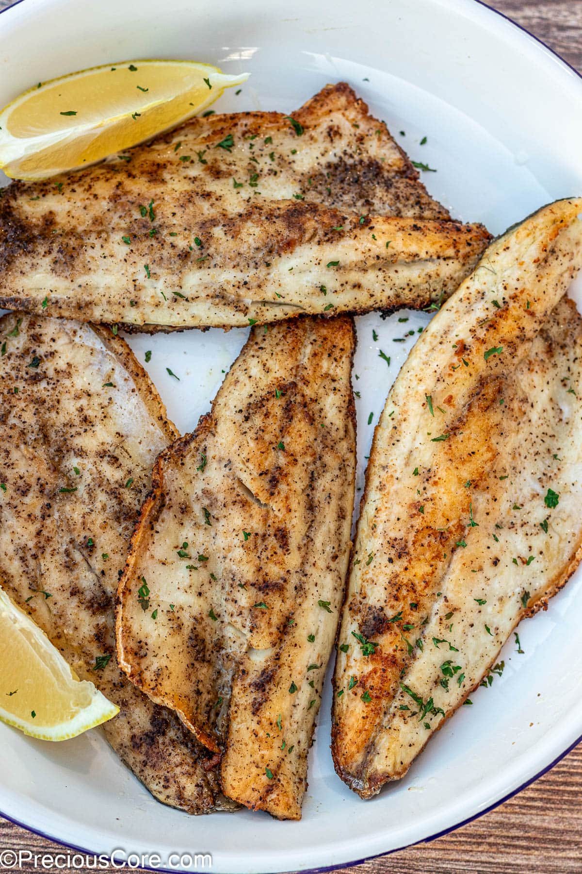 Pan Seared Sea Bass filets on a white plate.
