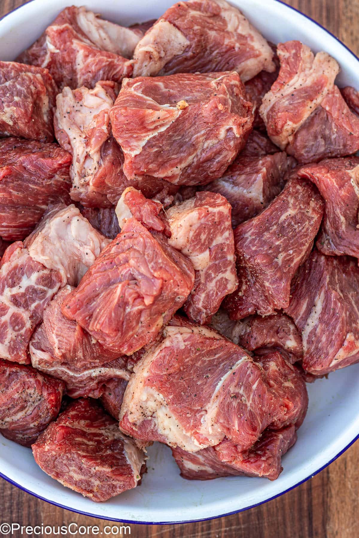 Seasoned beef in a white bowl.