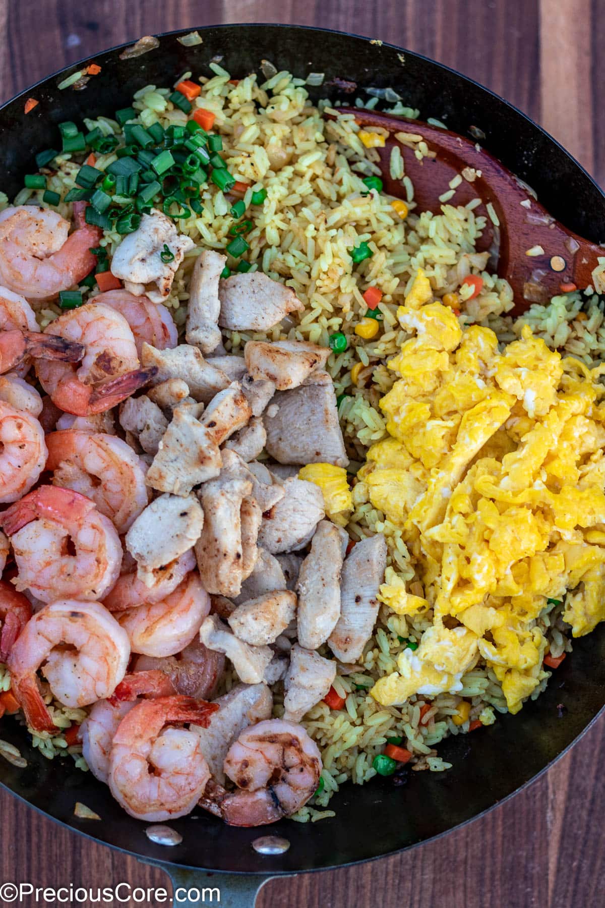 Fried rice topped with shrimp and chicken.