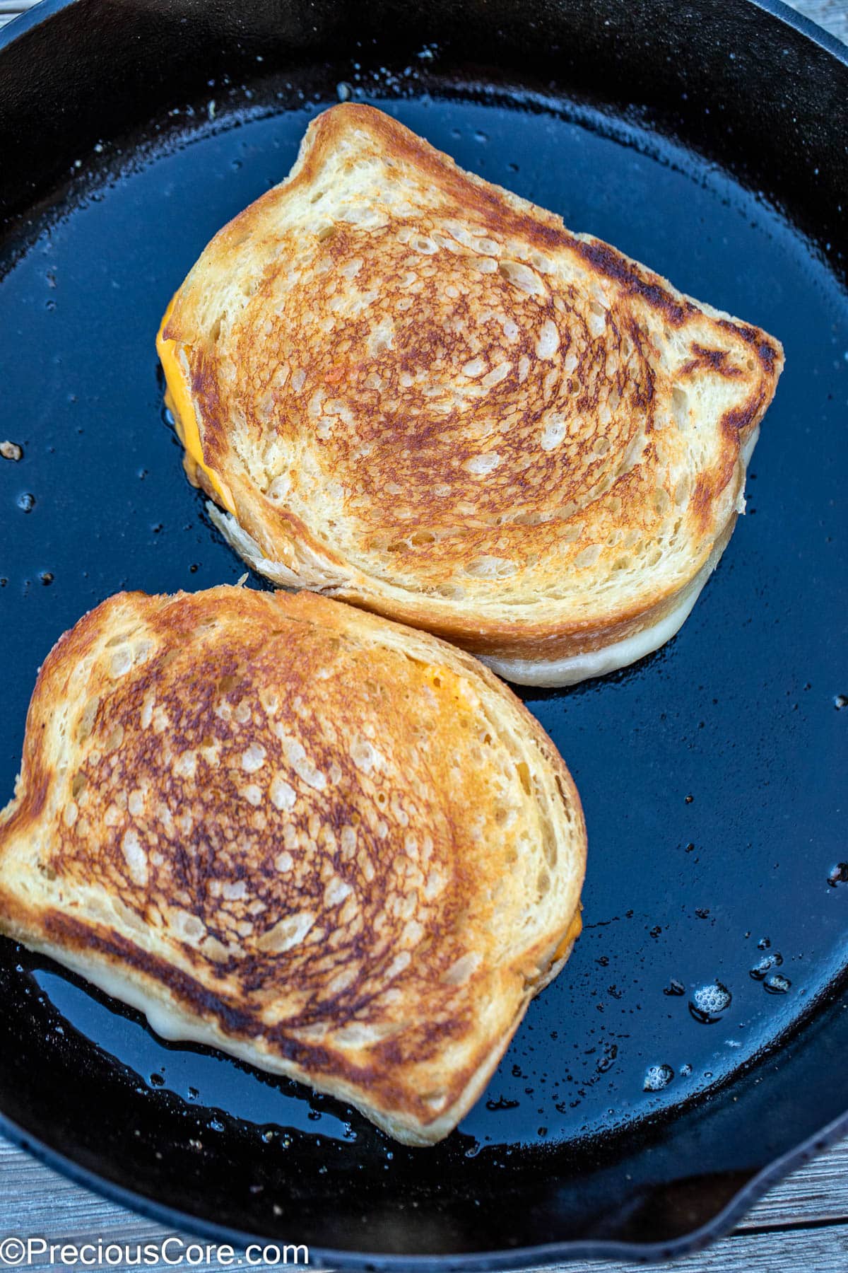 Sourdough grilled cheese in skillet.