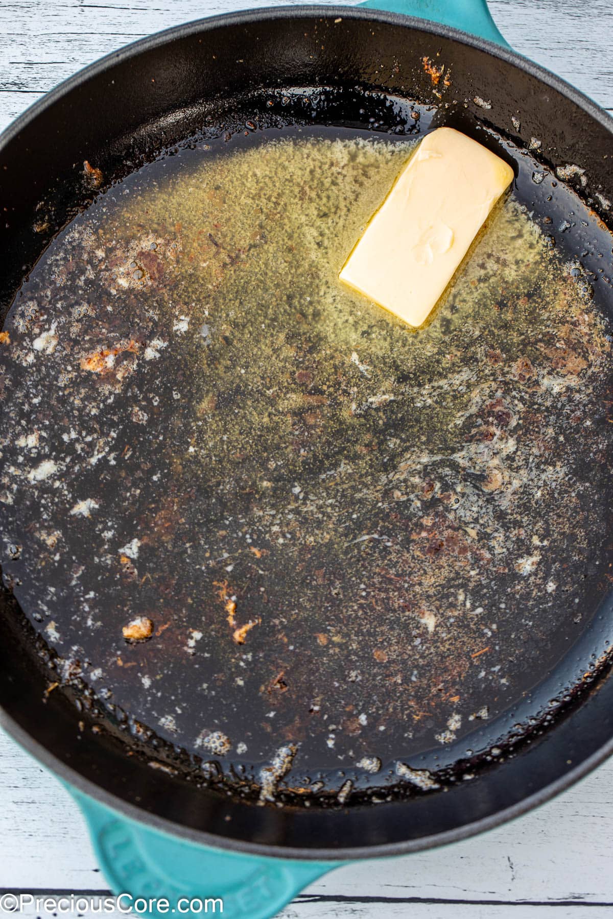 Butter melting in a cast iron skillet.