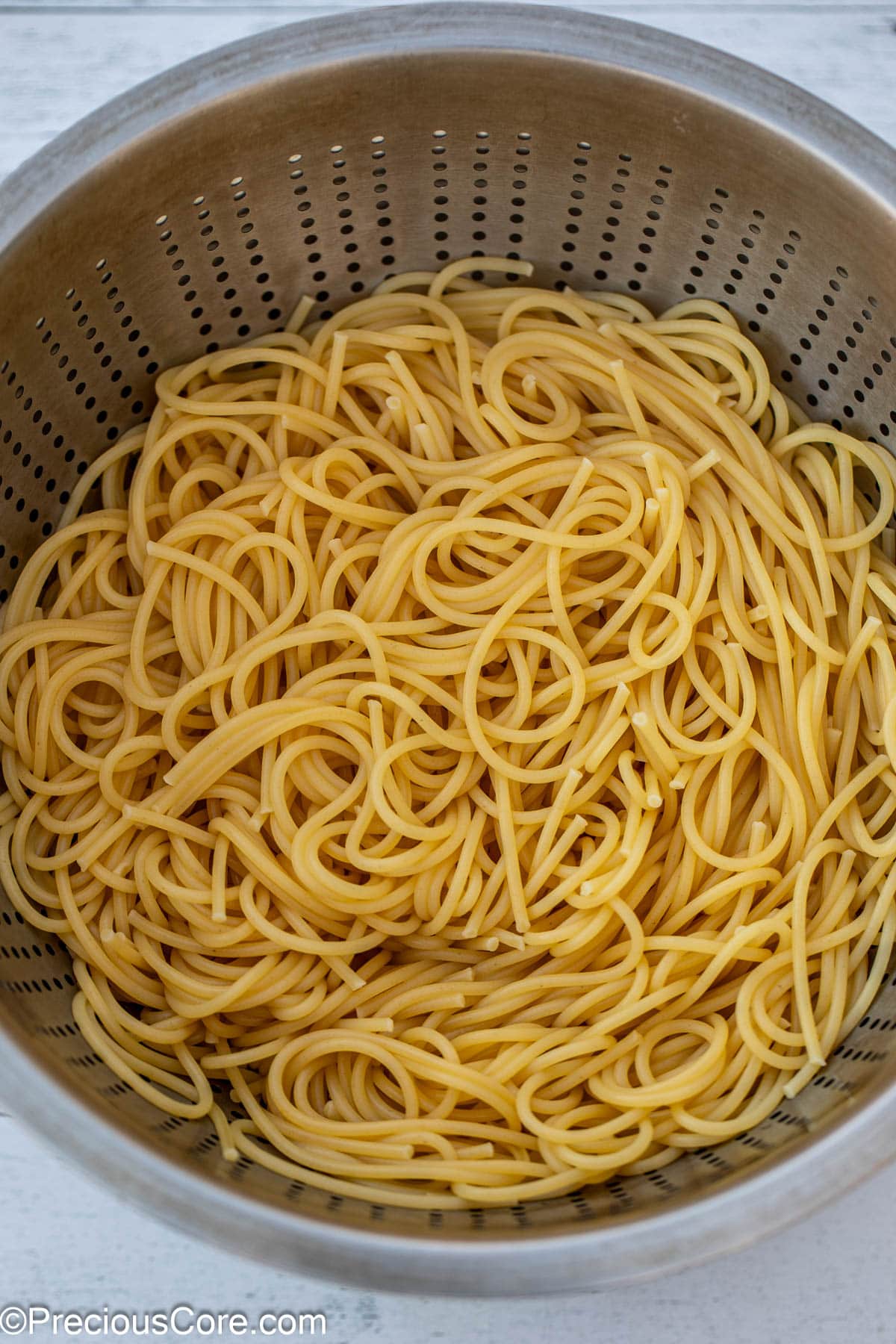 Cooked and strained spaghetti in a colander.