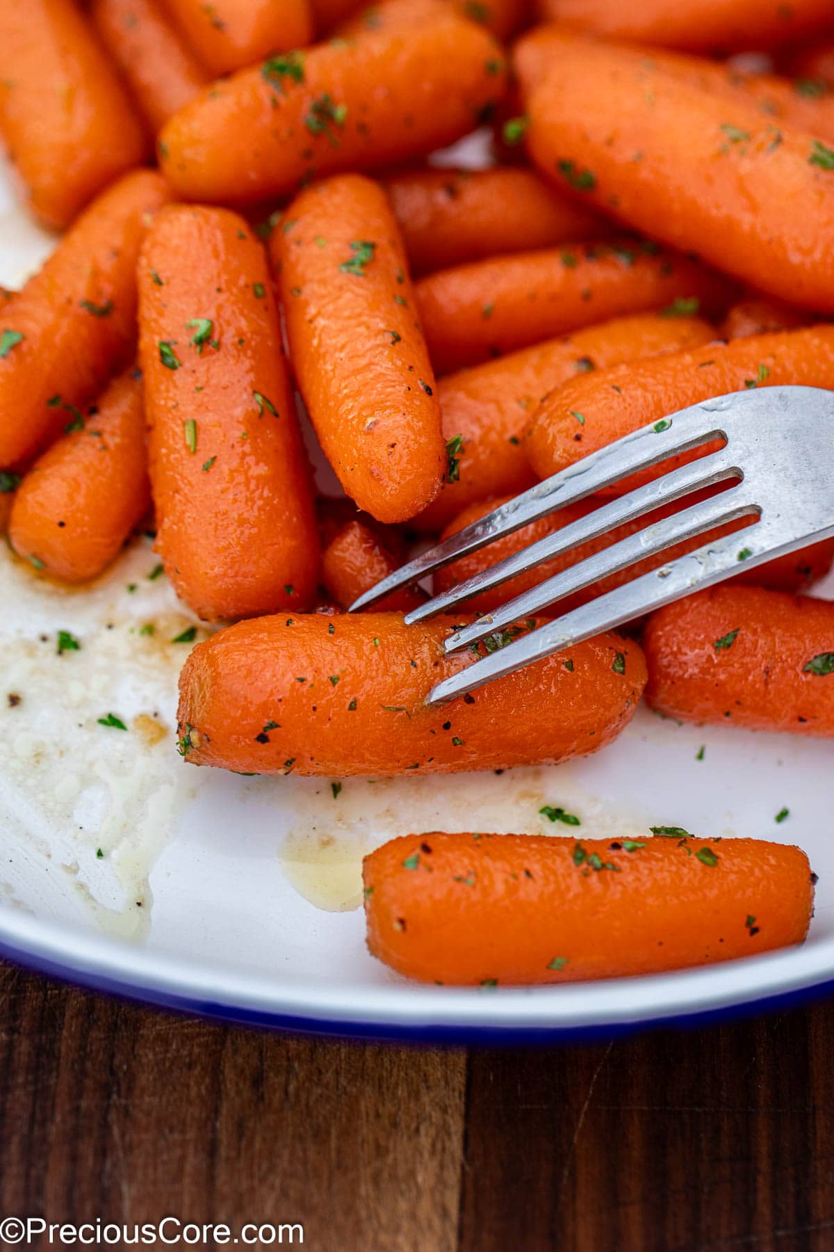 Fork piercing into a cooked carrot.