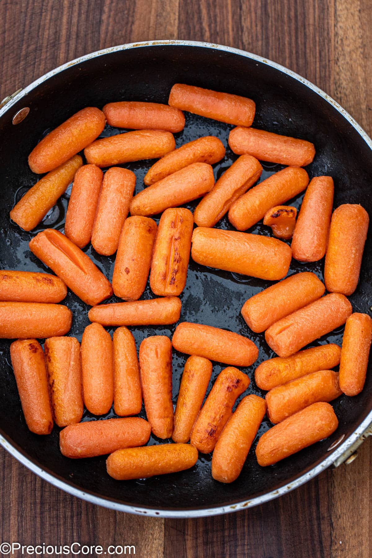 Carrots cooked in butter in skillet.