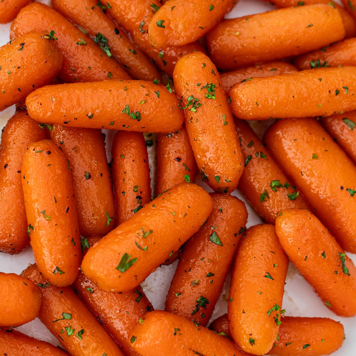 Square image of glazed carrots.